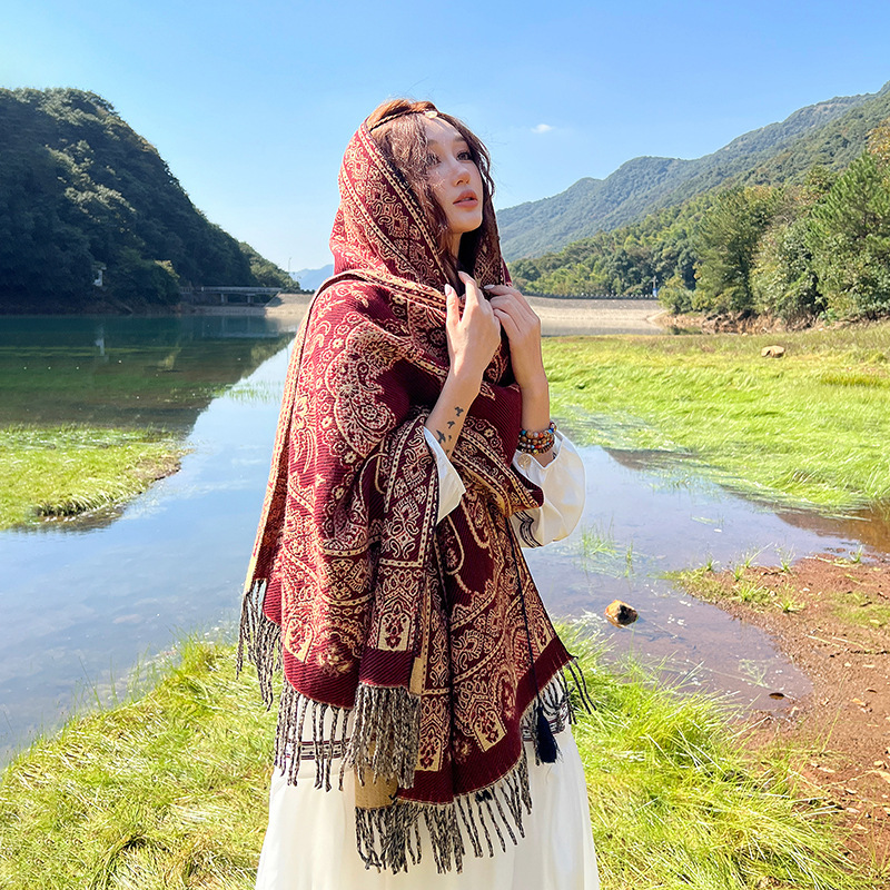 民族風のマフラーの女性は冬に保温エアコンの部屋のストールを厚くします。|undefined