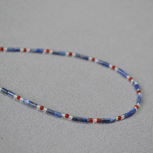 A handmade beaded necklace with new Chinese style, featuring a mix of vintage, literary, blue lapis lazuli, red agate, and genuine stones, with dot separators.
