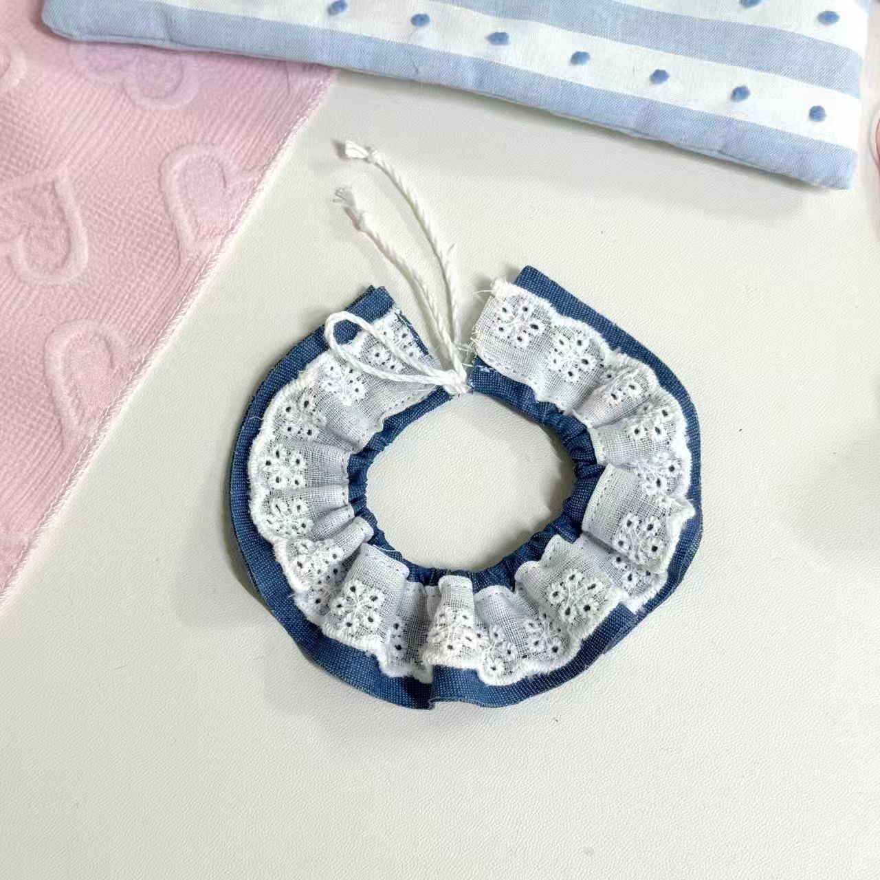 Blue background with white lace peter pan collar