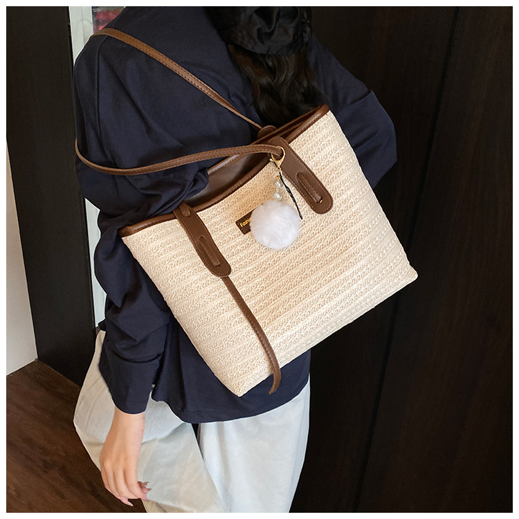 This is a new 2025 summer beach-style women's bag with a simple and versatile hand-held design. It's a single-shoulder vacation woven bag undefined