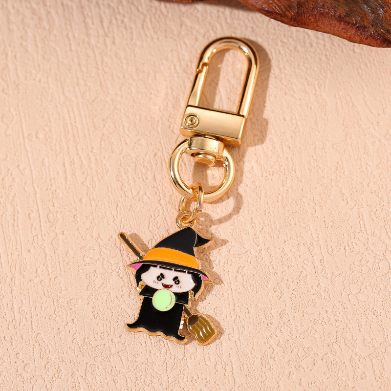 国境を越えてハロウィーンシリーズのアニメかわいいカボチャの頭帽の幽霊のキーホルダーに飾られた女性の本のストラップ|undefined