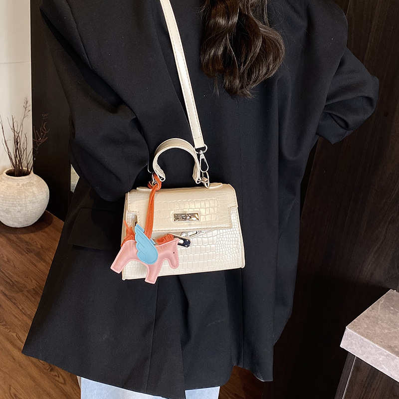 Bolso Kelly de mano de alta gama para mujer 2025 nueva moda casual bolso de hombro con patrón de piedra moda bolso de mensajero de color sólido