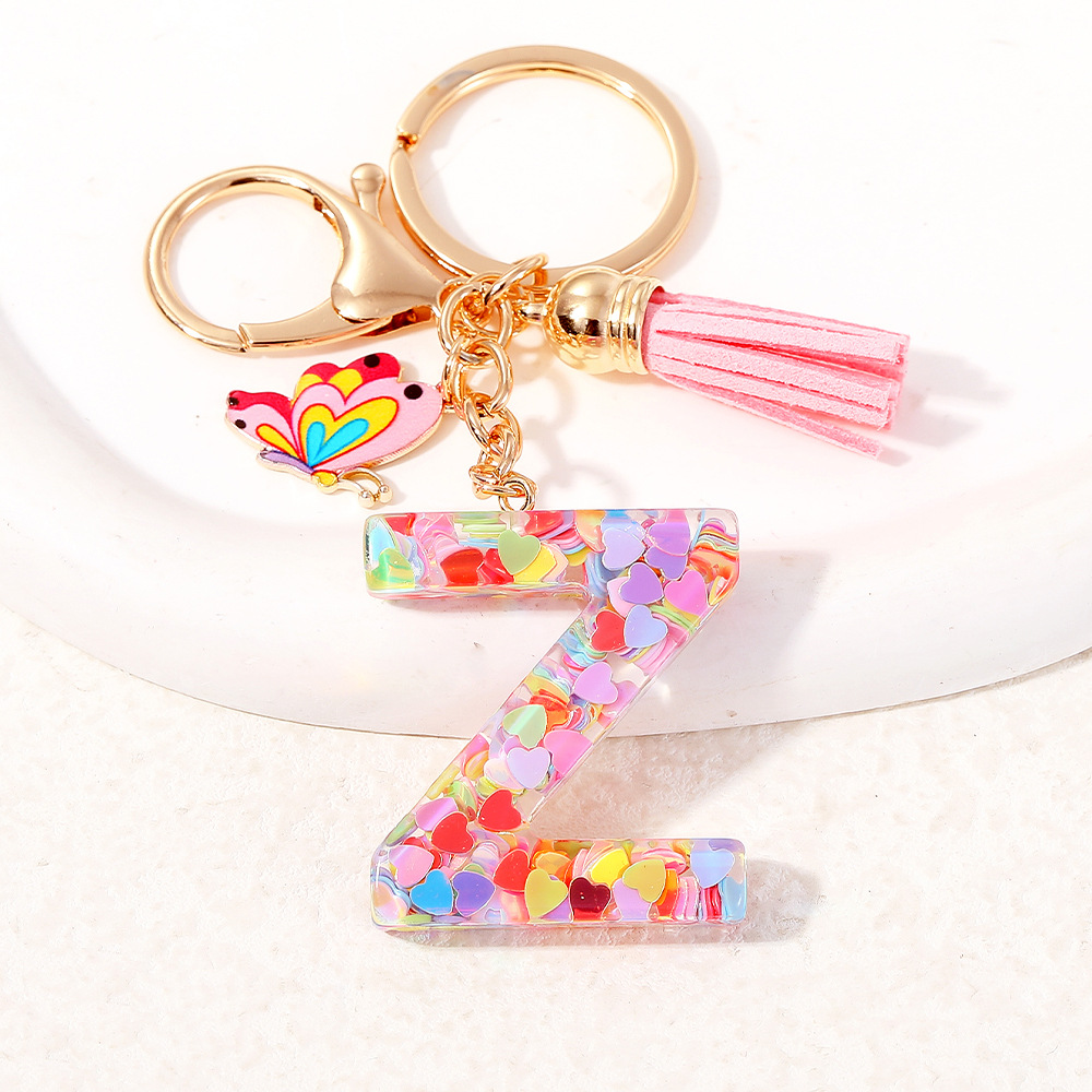 2024 puntos transfronterizos de resina de sequilla rosa 26 letras inglesas llavero colgante mariposa fringe accesorios