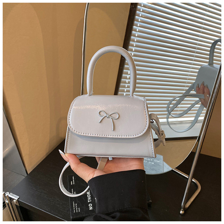 Bolsos infantiles transfronterizos dulces lindos arcos bolsos de mano de niña mini oso colgante bolsos de hombro