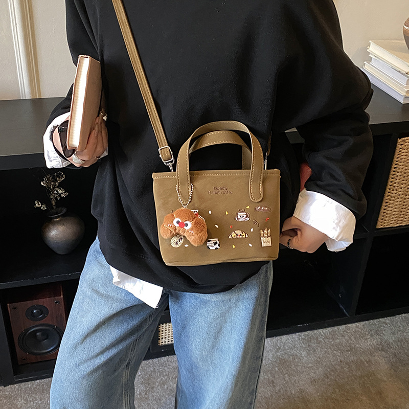 2026 nuevo comercio exterior bolsas de niños dibujos animados lindos colgantes de peluche bolsas de mano bordadas de moda bolsas de hombro para hombres y mujeres