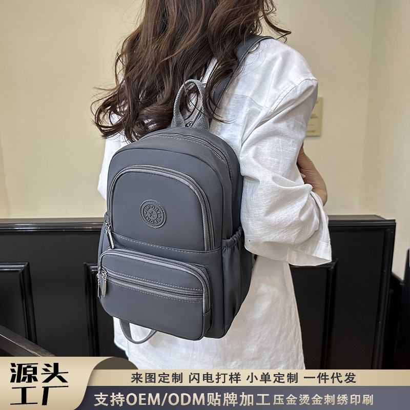 Mochila de mujer coreana versátil, ligera, impermeable y resistente al desgaste, mochila de tela Oxford, fuente transfronteriza, bolso estudiantil Baigou.