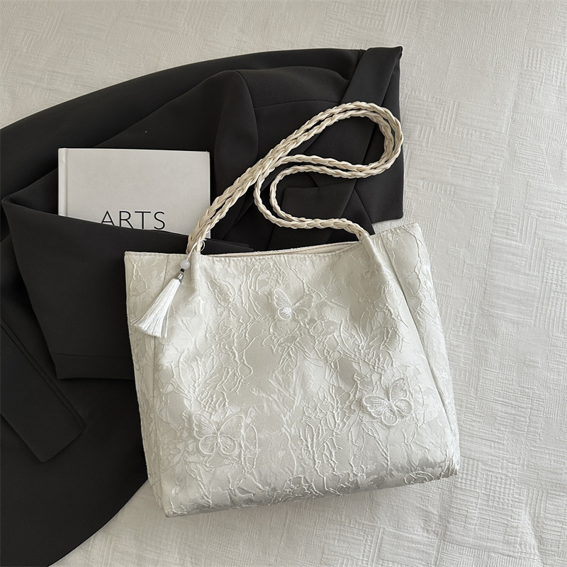 Bolso de viaje de seda de mariposa de alta calidad de nicho 2025 verano nuevo bolso de mujer simple de gran capacidad nuevo estilo chino