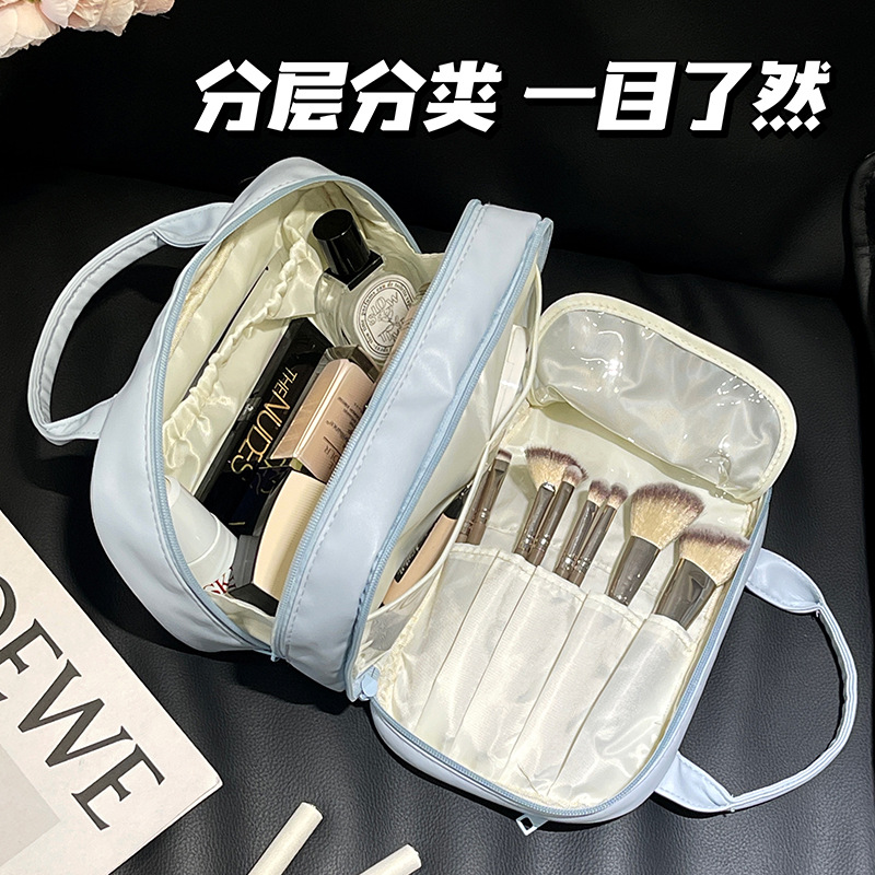 2024 nueva bolsa de maquillaje portátil PU de viaje portátil bolsa de almacenamiento de doble capa de gran capacidad bolsa de alta calidad