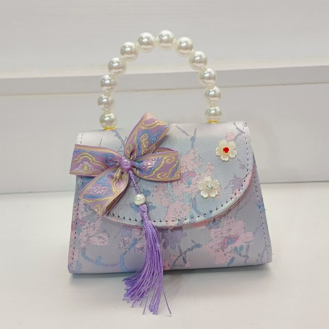Bolsas de niños arco de estilo chino borda de niña pequeña princesa perla bolsa de cambio de mano al por mayor