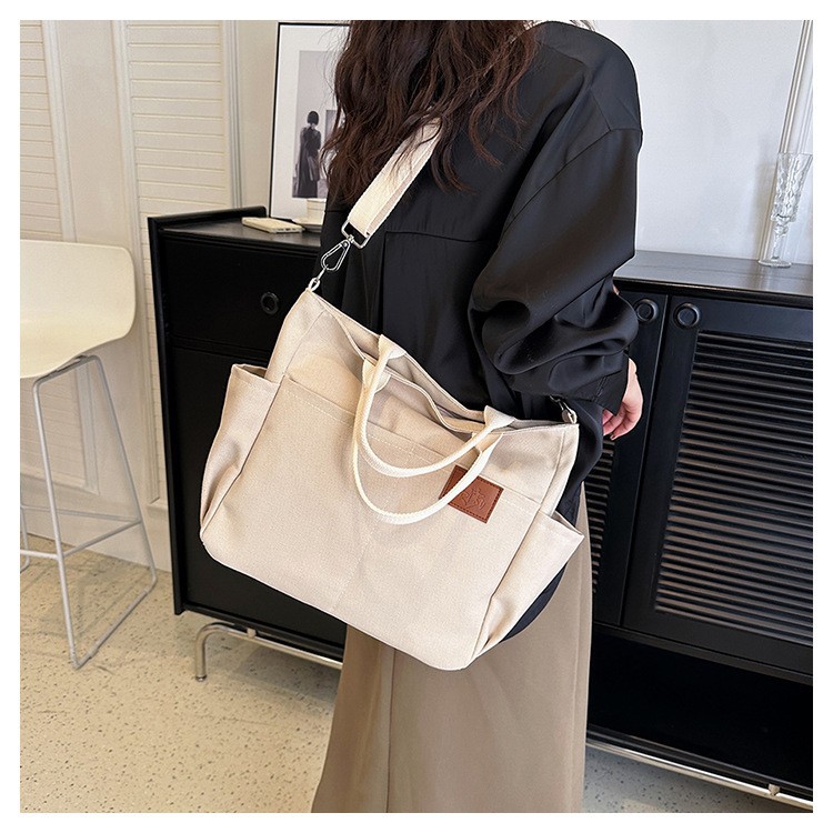 Bolso de lona con diseño de nicho, nuevo bolso tote de gran capacidad, bolso de hombro versátil para ir al trabajo, bolso informal para mujer