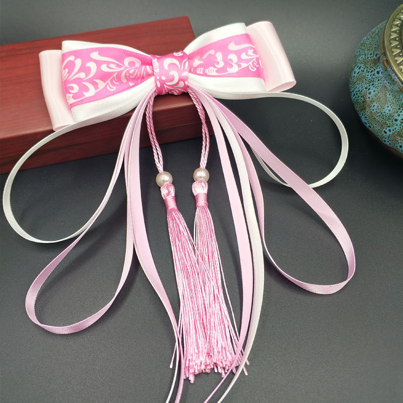 Red blue and white hairgrip with tassels