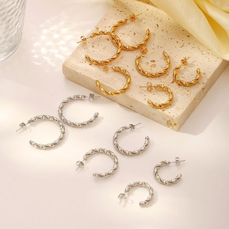 Aretes transfronterizos de moda de acero inoxidable tendencia simple torsión aretes redondos joyería de mujer al por mayor
