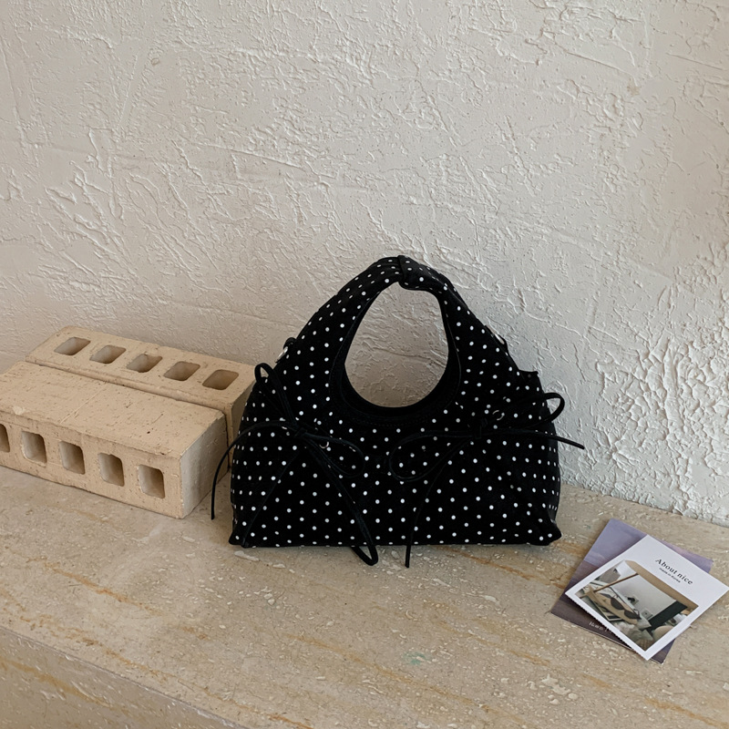 Bolsa de mano de arco exquisita coreana para mujeres verano 2026 simple diaria versátil onda punto sensación de hombro mochila