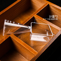 Dual-purpose mask measuring spoon with dual heads&mdash;ideal for both liquids and powders, featuring individual packaging and a plastic, graduated design.