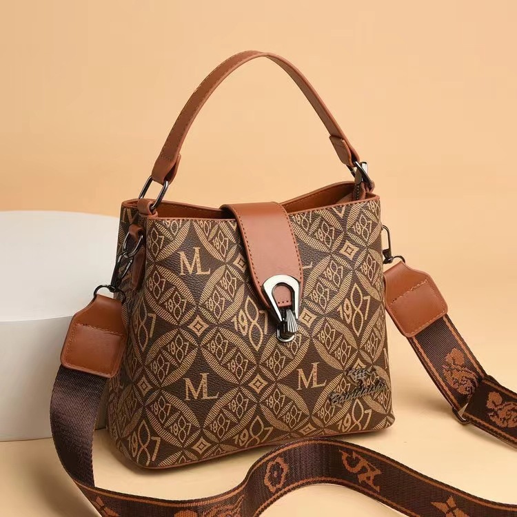 Bolso de cubo de sensación de alta gama para mujer 2025 verano nuevo bolso de hombro clásico de todo fósforo diseño de nicho bolso de mensajero portátil