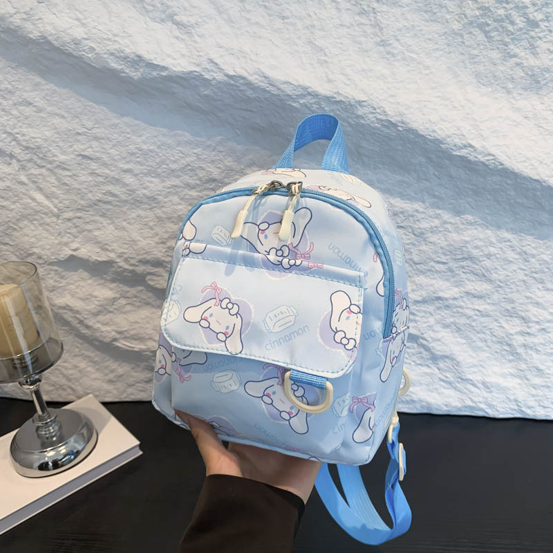 Mochila nueva al por mayor 2025, mochila de tela Oxford con diseño de dinosaurio de dibujos animados, mochila pequeña de gran capacidad para actividades al aire libre y ocio.