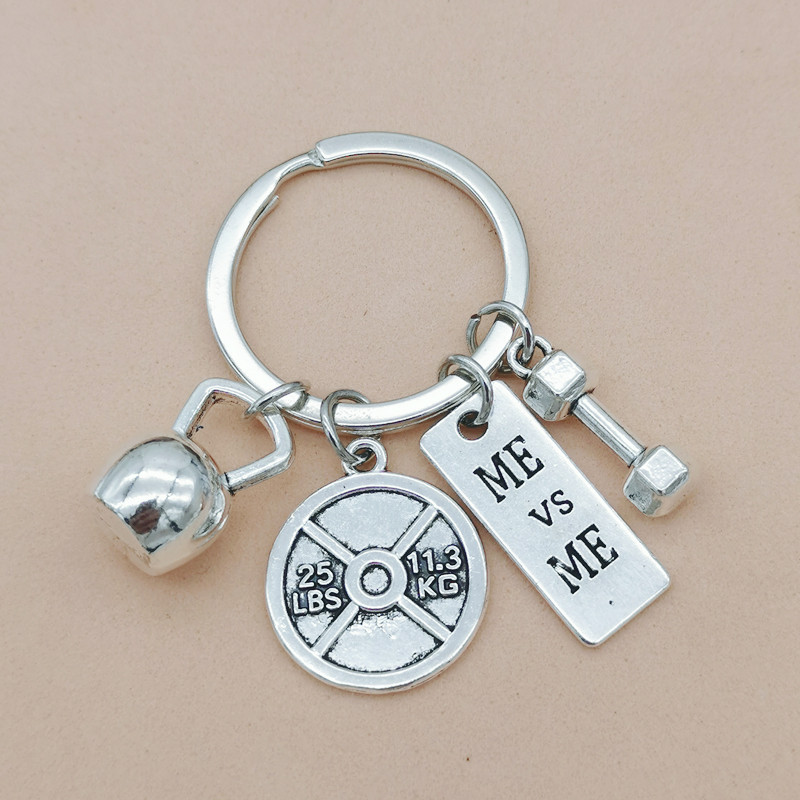 Nueva joyería europea y americana deportes poder mancuerna barra hervidor campana llavero hombres y mujeres pareja amistad llavero