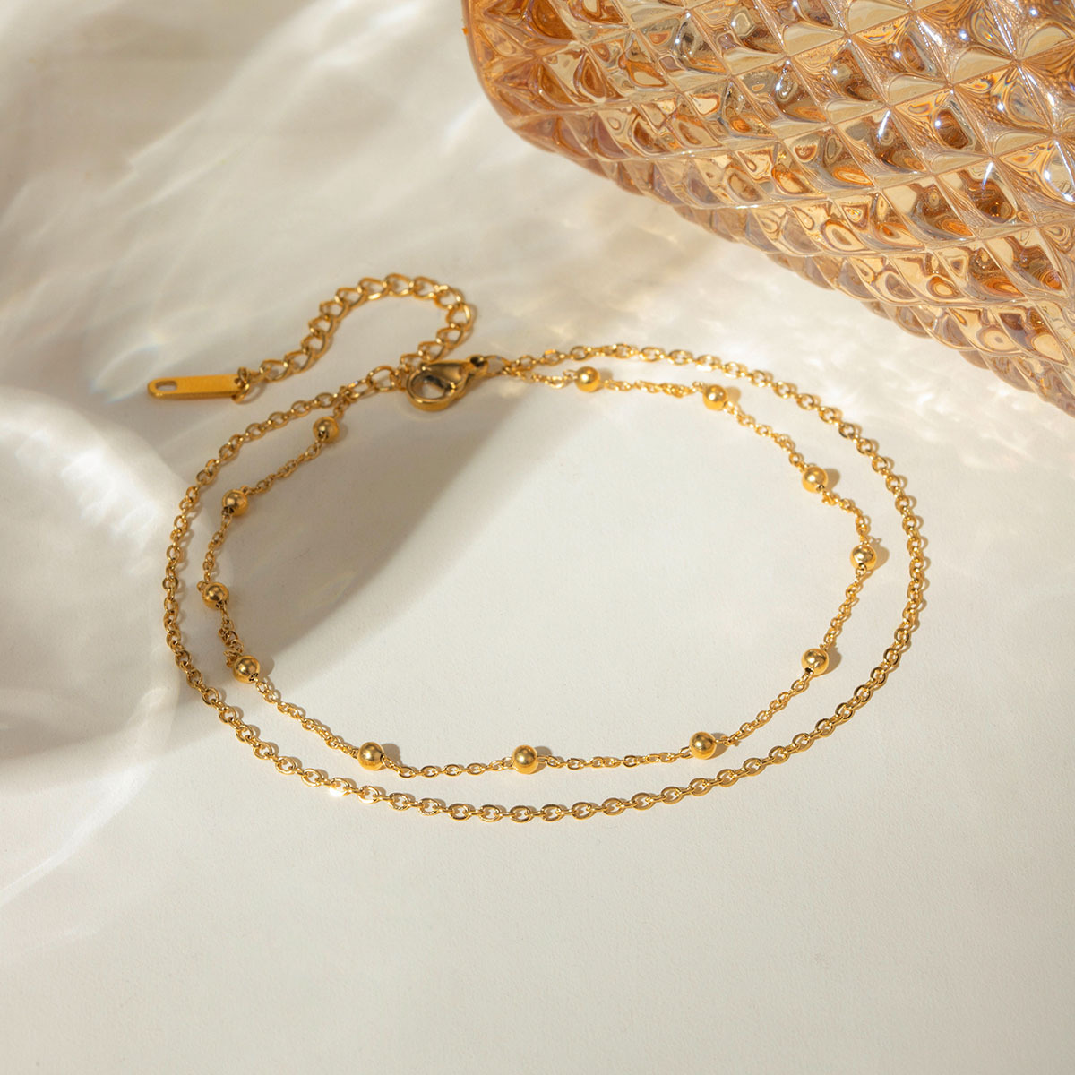 Accesorios de verano nuevos nichos europeos y estadounidenses de moda versátil 18k oro acero inoxidable doble cadena de bolas joyerías de tobillas para mujeres