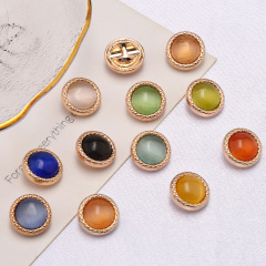 Metal button embellished cat's eye stone crewneck knit top with hand-stitched circular colorful dark eye small scented button decoration