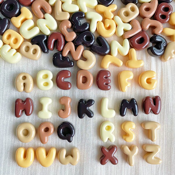 small brown accessories with letters