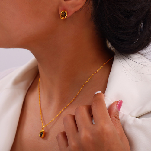 Vintage English-style niche accessory with an indented elliptical pendant featuring tiger's eye stone, designed titanium steel jewelry set