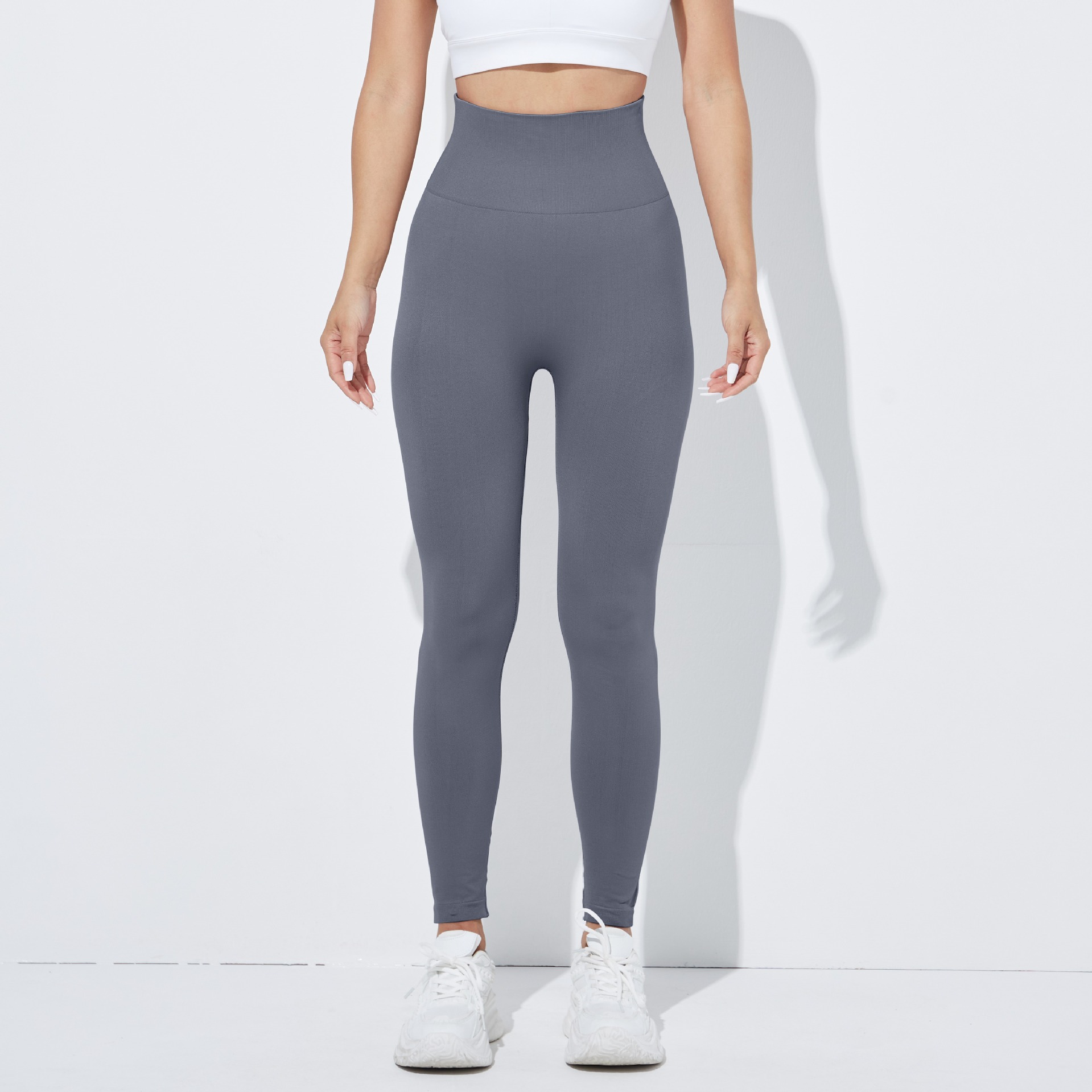Pantalones de yoga europeos y americanos sin costuras transfronterizas pantalones de fitness deportivos de levantamiento de cadera apretados de mujer ropa de Yoga de melocotón de cintura alta lisa
