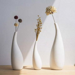 北欧風のシンプルな陶磁器の花瓶の置物の白い色の乾燥した花を焼いて家庭の装飾の飾り物のメーカーの卸売りを挿します。