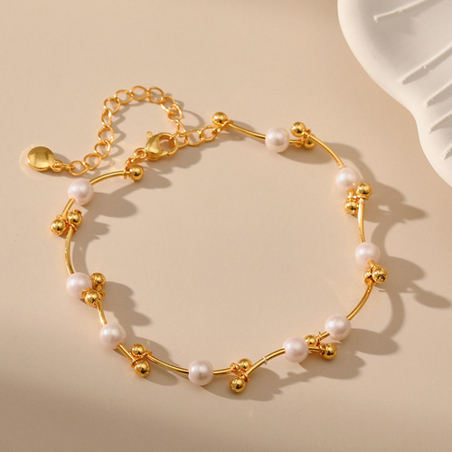 Pearl bracelet with a personalized knotted design, featuring golden round beads and copper tubing—perfect as a lucky charm to attract good fortune, crafted with 18K real gold plating.