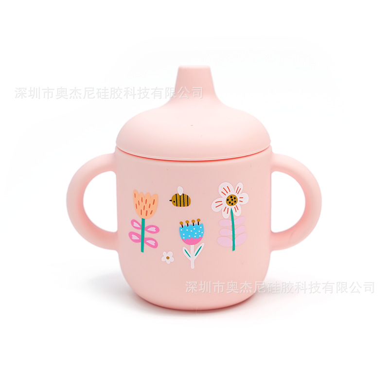 Taza de aprendizaje para bebés de silicona de grado alimenticio - 180 ml - Con boquilla y asas - Estampado disponible - En stock - Venta al por mayor