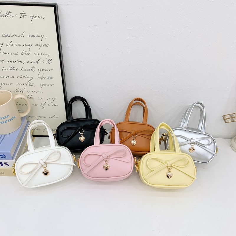Coreano simple color sólido bolso de hombro para niños y niñas mini bolso de bebé lindo dulce bolso de arco para niños