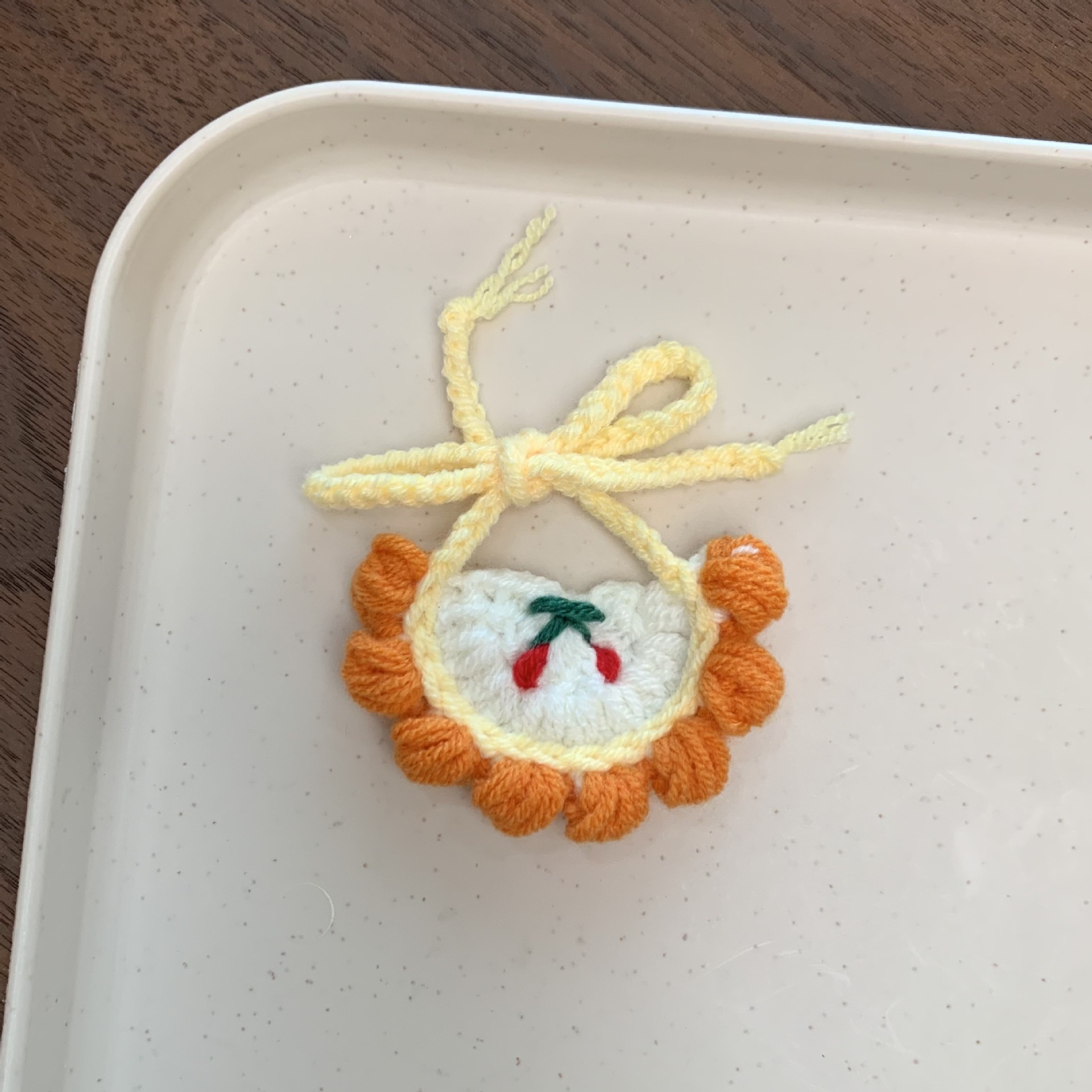 Cherry bib with orange edge and white background