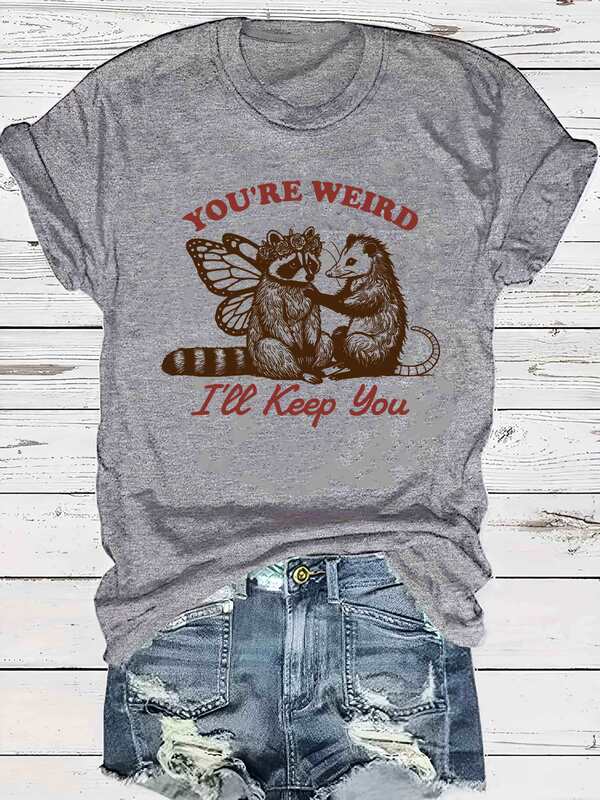 Vintage Raccoon and Opossum Graphic T-Shirt for Women - "You'Re Weird, I'M Keeping You" Slogan, Grey Vintage Raccoon and Opossum Graphic T-Shirt for Women - "You'Re Weird, I'M Keeping You" Slogan, Grey