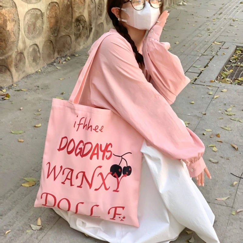 慵懒风粉色印花字母单肩包女学生大容量帆布包百搭上课通勤手提袋