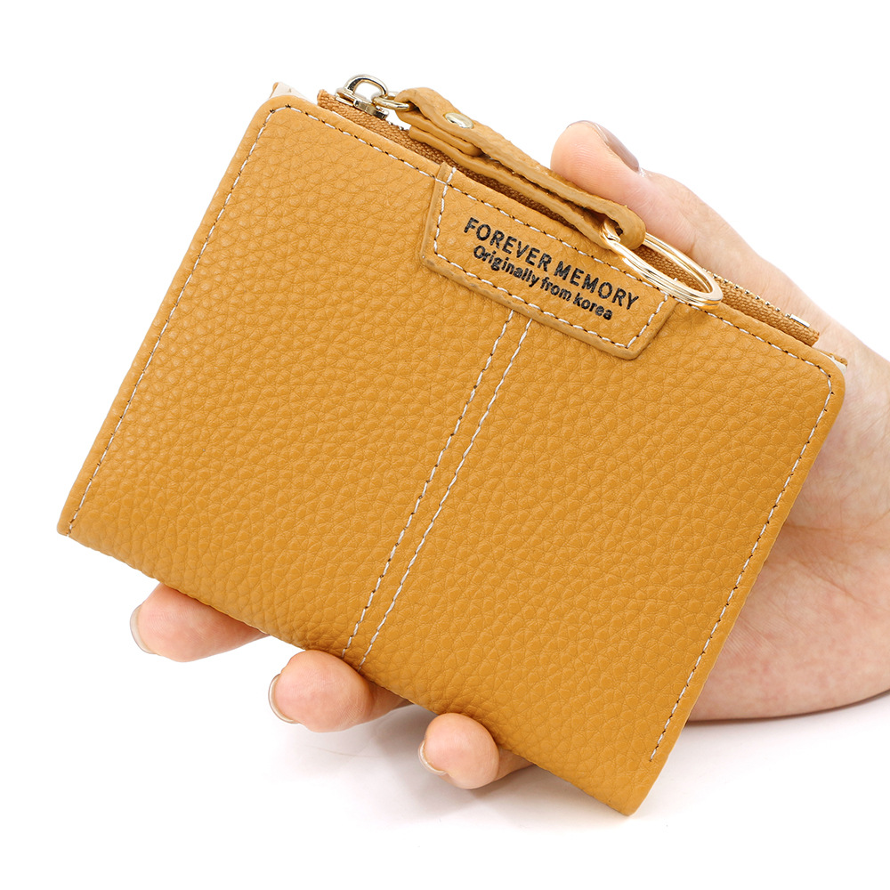 Versión coreana de la nueva billetera corta para mujer, llavero simple, billetera de monedas, billetera de dos pliegues para estudiantes al por mayor