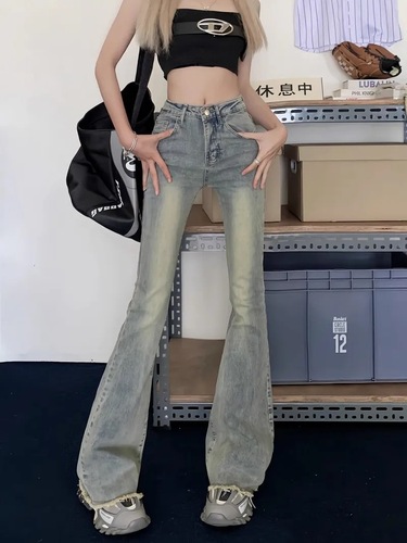 Slightly flared denim jeans for women: vintage autumn style, high waist, slimming fit, with a niche design and raw-edge hem.