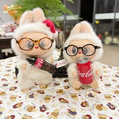 A set of accessories for the Coca-Cola LABUBU plush doll, including glasses, a hat, and shoes, featuring a design inspired by the first, second, and third generations of the iconic Coca-Cola MACARON plush doll.