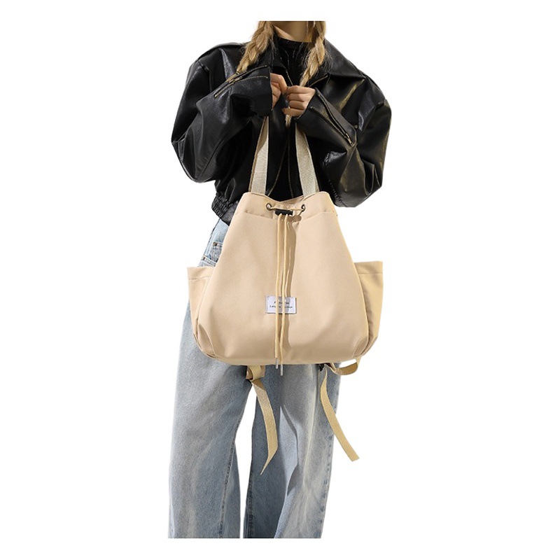 Alta textura de nylon fresco dulce bolsa de las mujeres bolsa 2023 invierno nuevo color sólido cordón bolsa mochila bolso