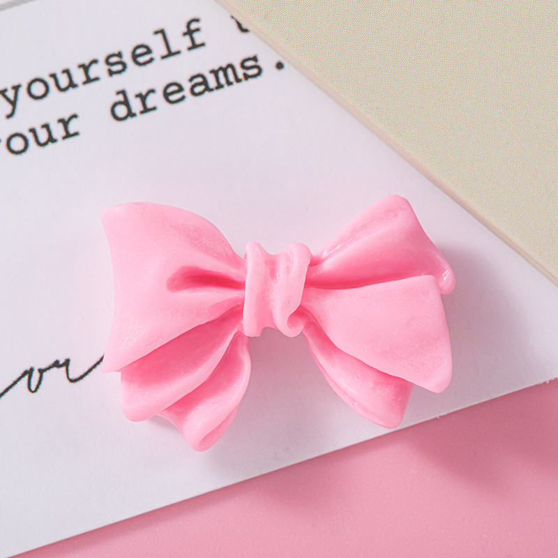 Accesorios de resina de arco de color macaron DIY Crema Accesorios de cuerda de cabello de agujero de caja de teléfono móvil Colgante de hebilla de zapato