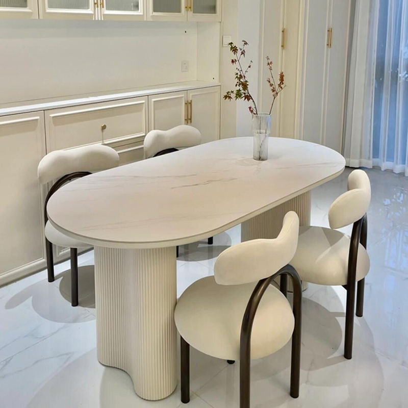 Mesa de comedor ovalada de roca francesa lujosa crema de lujo ligera de alta gama moderna y simple columna de cacahuete silla de viento silencioso combinación de mesa de comedor