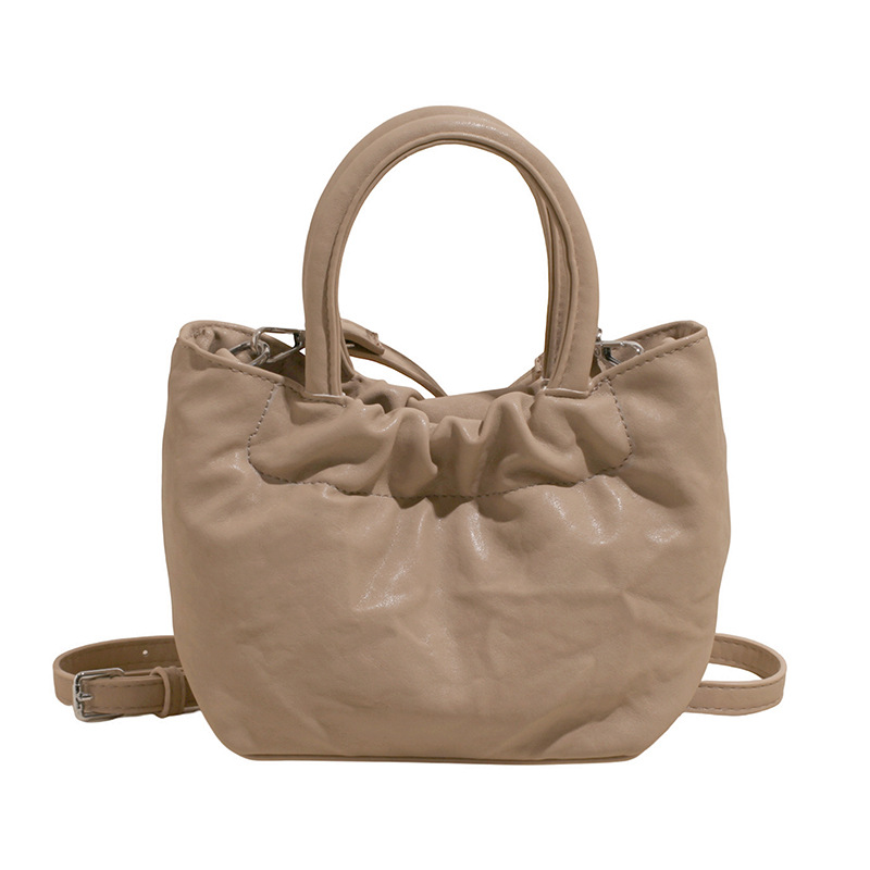 2025 nuevo bolso de cubo portátil de color sólido de diseño de nicho para mujer, bolso de mensajero de un solo hombro simple y moderno de alta gama para mujer