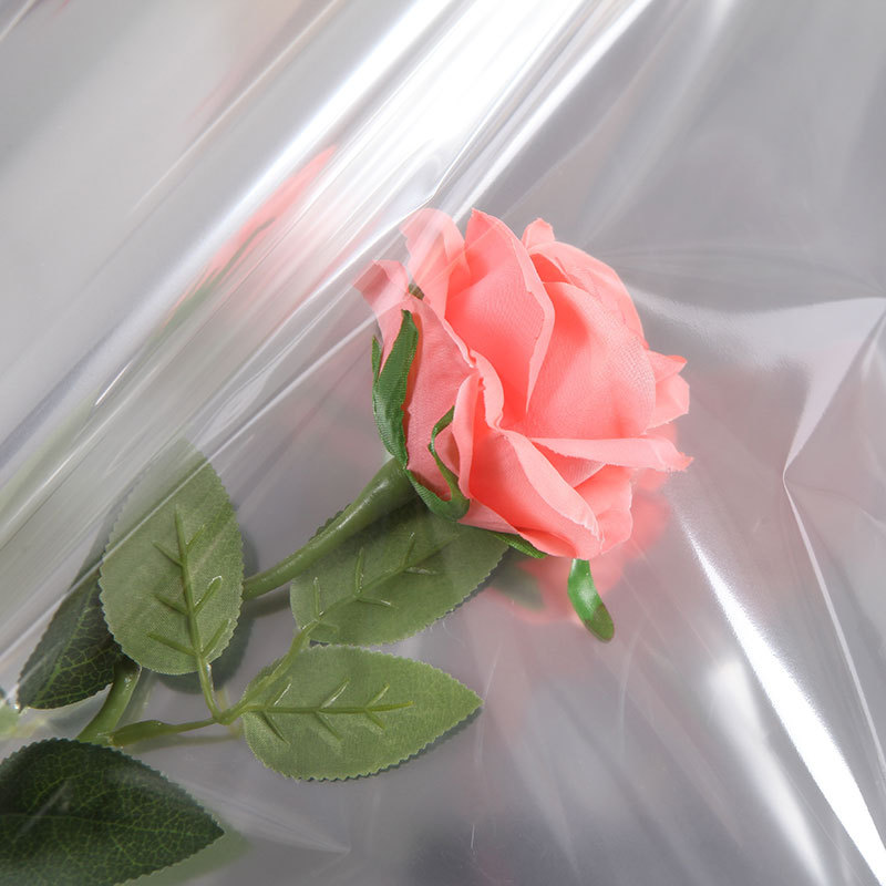 Celofán transparente plástico flor papel de embalaje ramo base hecha a mano rollo transparente flor tienda floral material en stock al por mayor