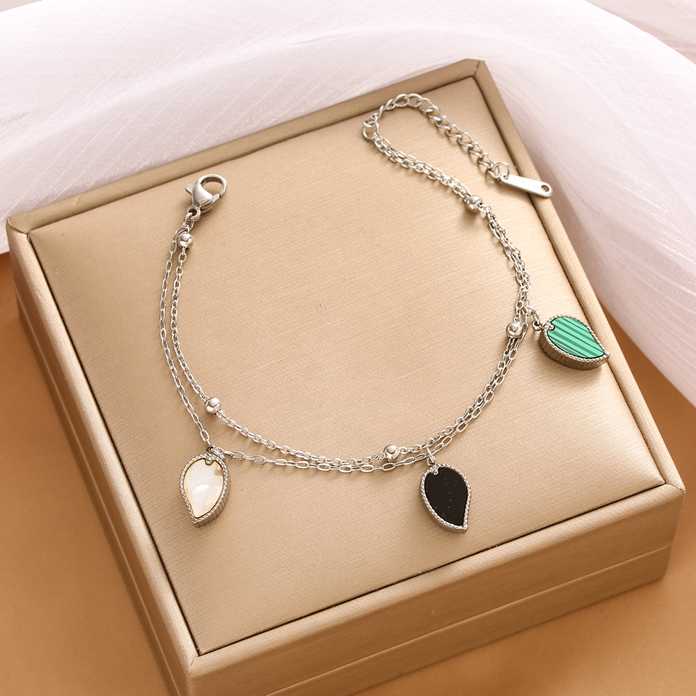 Pulsera de trébol de acero titanium vendedora caliente transfronteriza europea y americana con incrustaciones de concha pulsera colgante pulsera de diseño avanzado sin desvanecimiento al por mayor