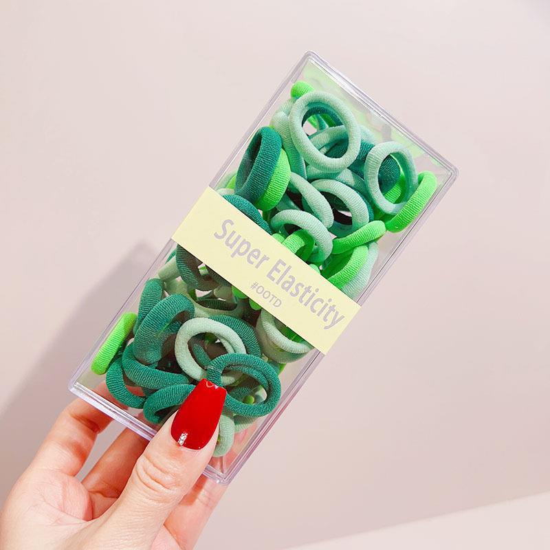 Asequible caja de almacenamiento de Corea del Sur de los niños pequeño tamaño cabeza cuerda bebé toalla anillo no duele pelo cabeza cuerda macaron pelo anillo