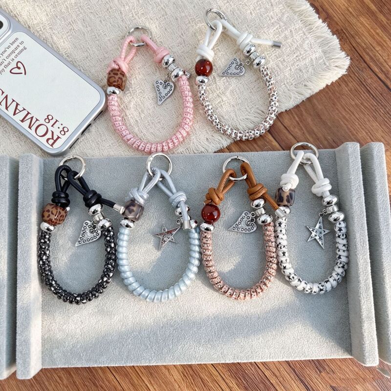 Trendy leopard-print woven phone strap with a creative heart-shaped pendant, a new 2026 design with a unique and niche aesthetic