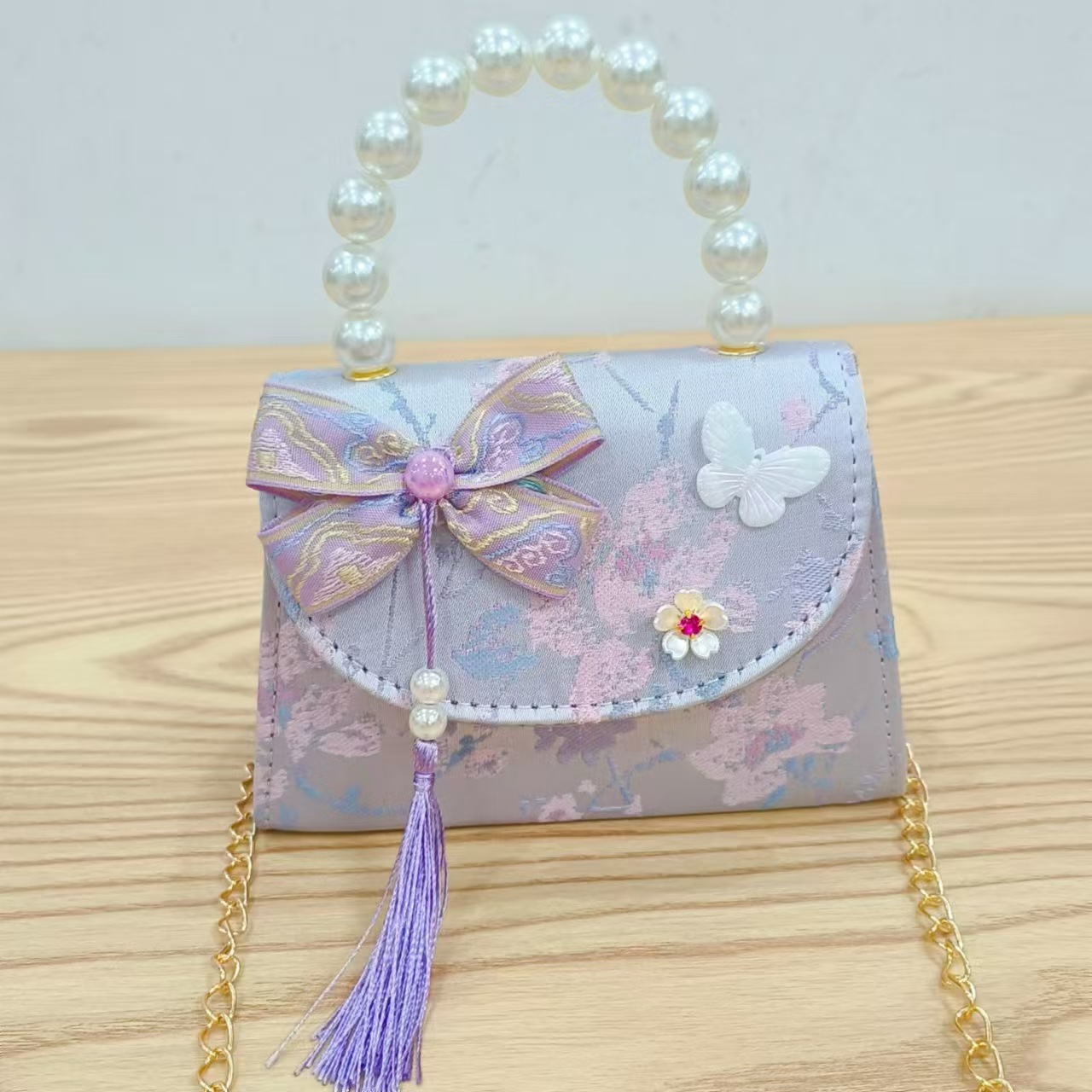 202 nuevo arco de estilo nacional bolsos para niños pequeños bolsos de moda de perlas de moda princesa bolsos de mano inclinados