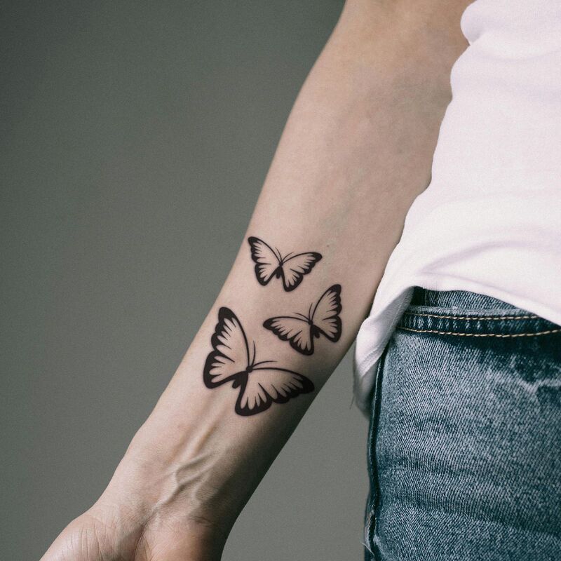 Black and white silhouette three butterflies tattoo sticker, minimalist style, staggered size butterflies, waterproof sticker for collarbone and forearm