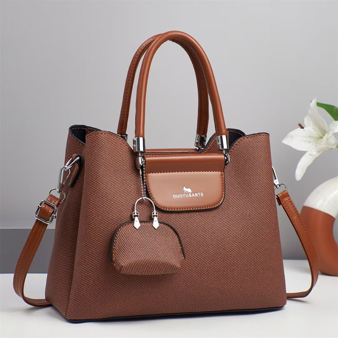 El nuevo bolso de mano para niños y madres está de moda en el bolso de hombro de textura, bolso de mensajero de diseño de nicho coreano de todo fósforo, comercio exterior