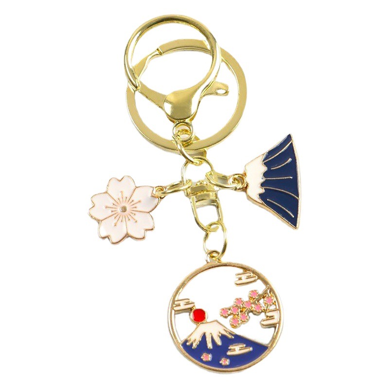 富士山合金の滴るオイルのキーは新型の創意的な透かし彫りの雪山の桜の包みのペンダントのairpodsを掛けて飾ります。