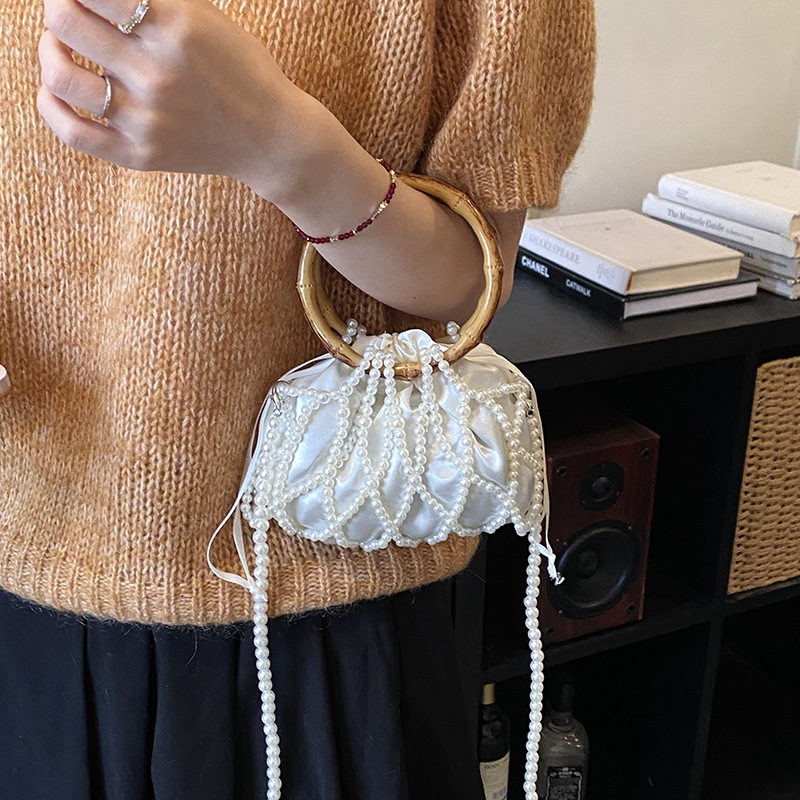 Nueva bolsa china de tejido para niños y niñas bolsas de hombro de perlas de bambú hueco bolsas de mano pequeñas bolsas de cuerda de dibujo para niños