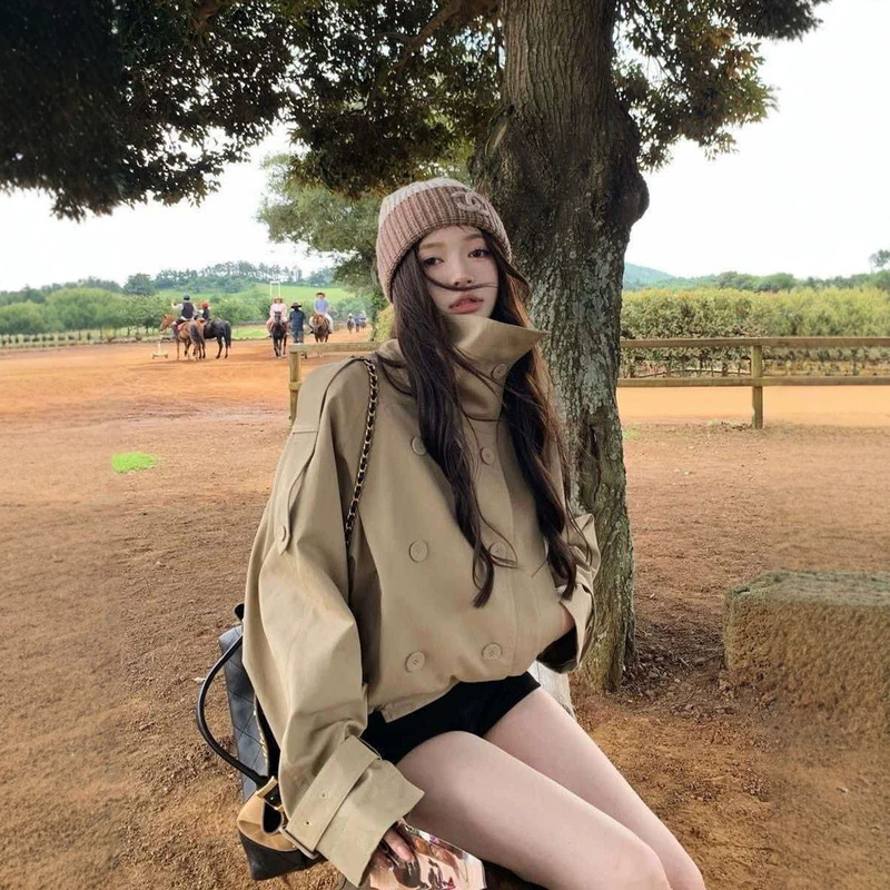 Early autumn, uniquely beautiful, stunning, and incredibly stylish: a short, double-breasted khaki trench coat jacket for women